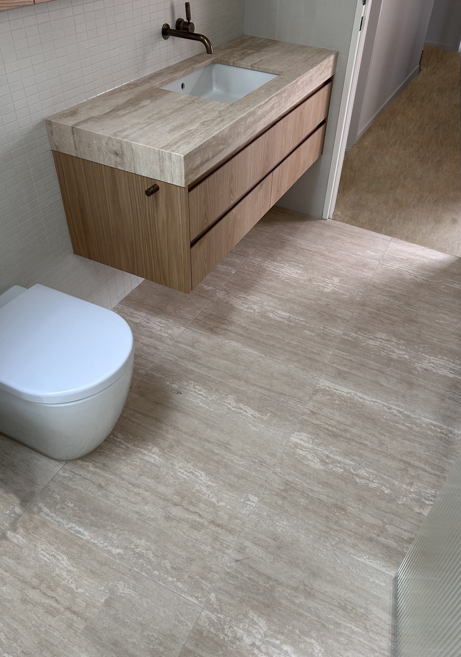 High-end bathroom tiling and vanity used our Classic Light natural travertine vein cut unfilled, Atlas Tile & Stone. Supplier of natural stone tiles in Moorabbin