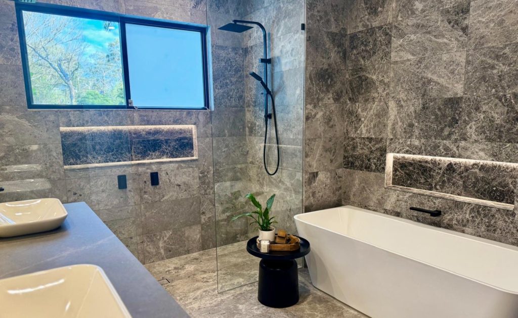 modern natural stone bathroom used tundra black limestone supplied by Atlas Tile & Stone. Tiles showroom in Moorabbin